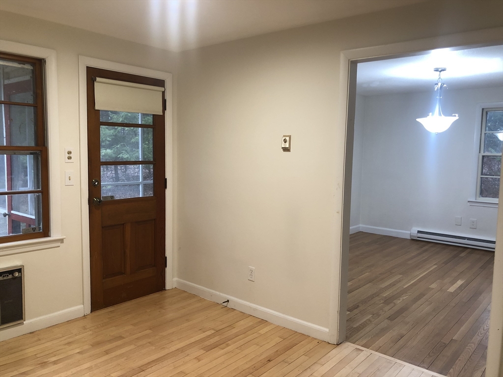 53 Deerhaven Road, Unit 1 Lincoln, MA 01773 - Photo 16 of 42 a view of an empty room with wooden floor and a window