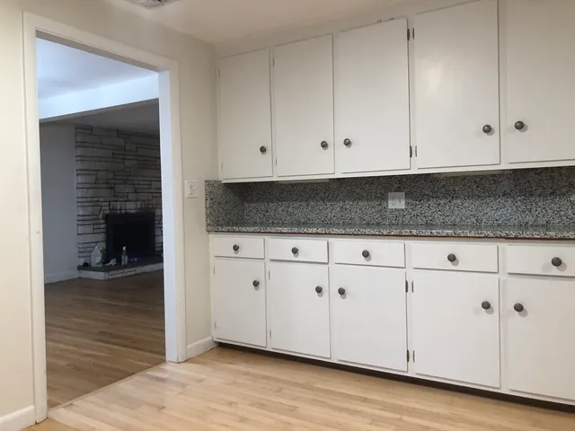 wooden floor in an empty room and a window