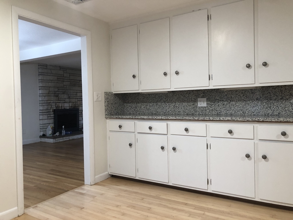 53 Deerhaven Road, Unit 1 Lincoln, MA 01773 - Photo 17 of 42 a kitchen with granite countertop white cabinets and sink