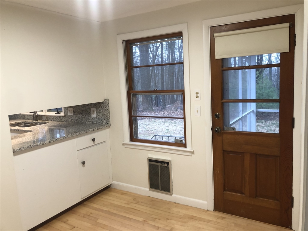 53 Deerhaven Road, Unit 1 Lincoln, MA 01773 - Photo 18 of 42 wooden floor in an empty room and a window
