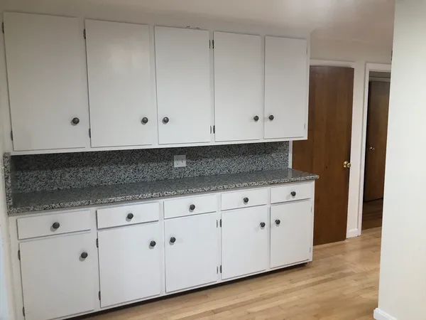 a kitchen with granite countertop a stove and a sink