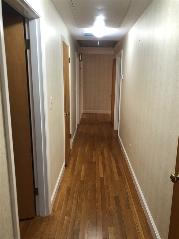 53 Deerhaven Road, Unit 1 Lincoln, MA 01773 - Photo 24 of 42 a view of a hallway with wooden floor