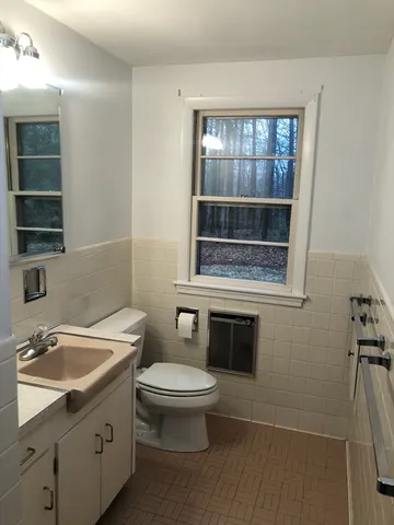 a bathroom with a tub toilet and shower