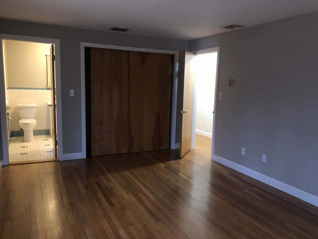 53 Deerhaven Road, Unit 1 Lincoln, MA 01773 - Photo 31 of 42 wooden floor in an empty room with a window