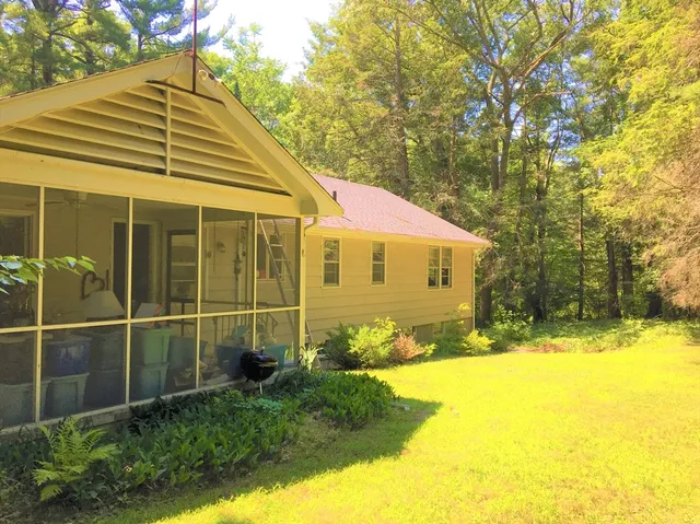 wooden floor fireplace and windows in an empty room