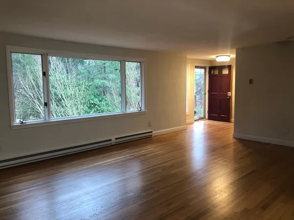 a view of a room with wooden floor