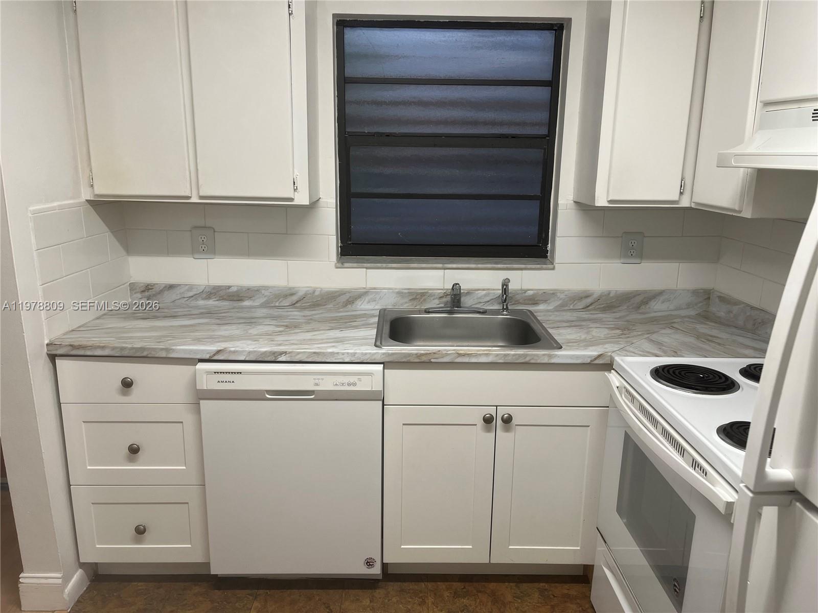 1250 Lincoln Road, Unit 310 Miami Beach, FL 33139 - Photo 14 of 27 a kitchen with granite countertop cabinets appliances and a sink