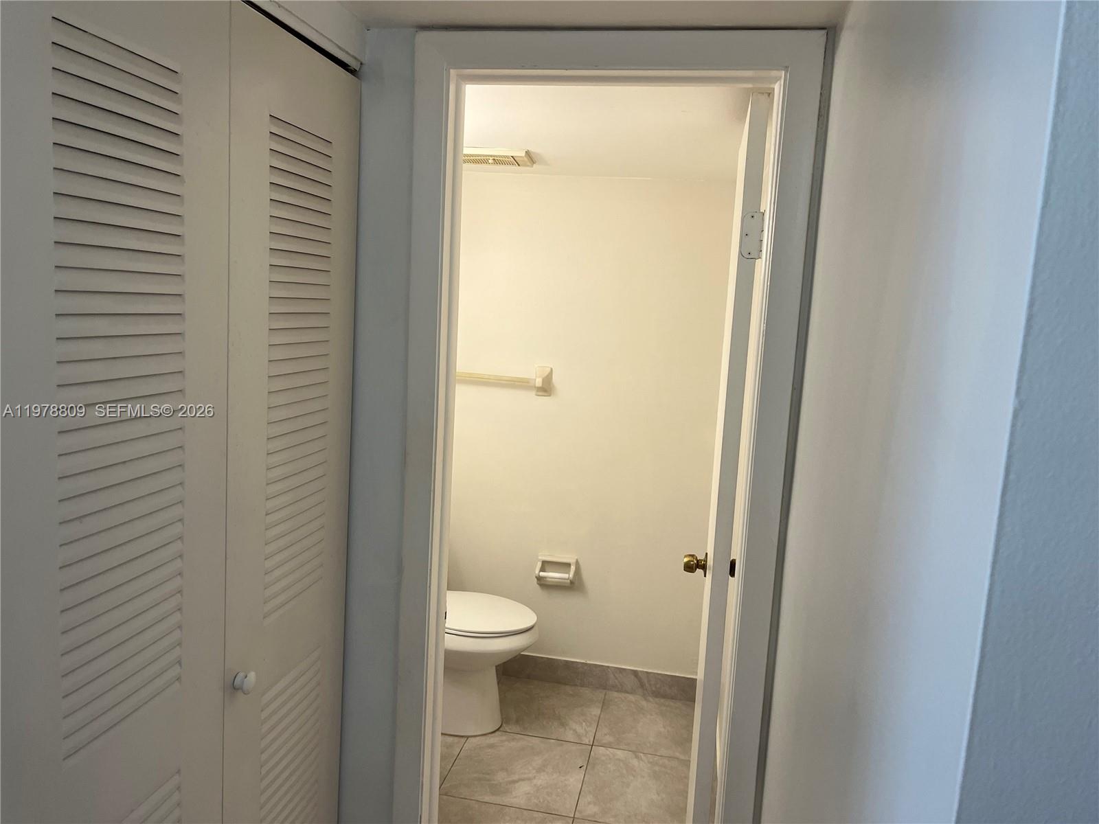 1250 Lincoln Road, Unit 310 Miami Beach, FL 33139 - Photo 15 of 27 a bathroom with a granite countertop sink