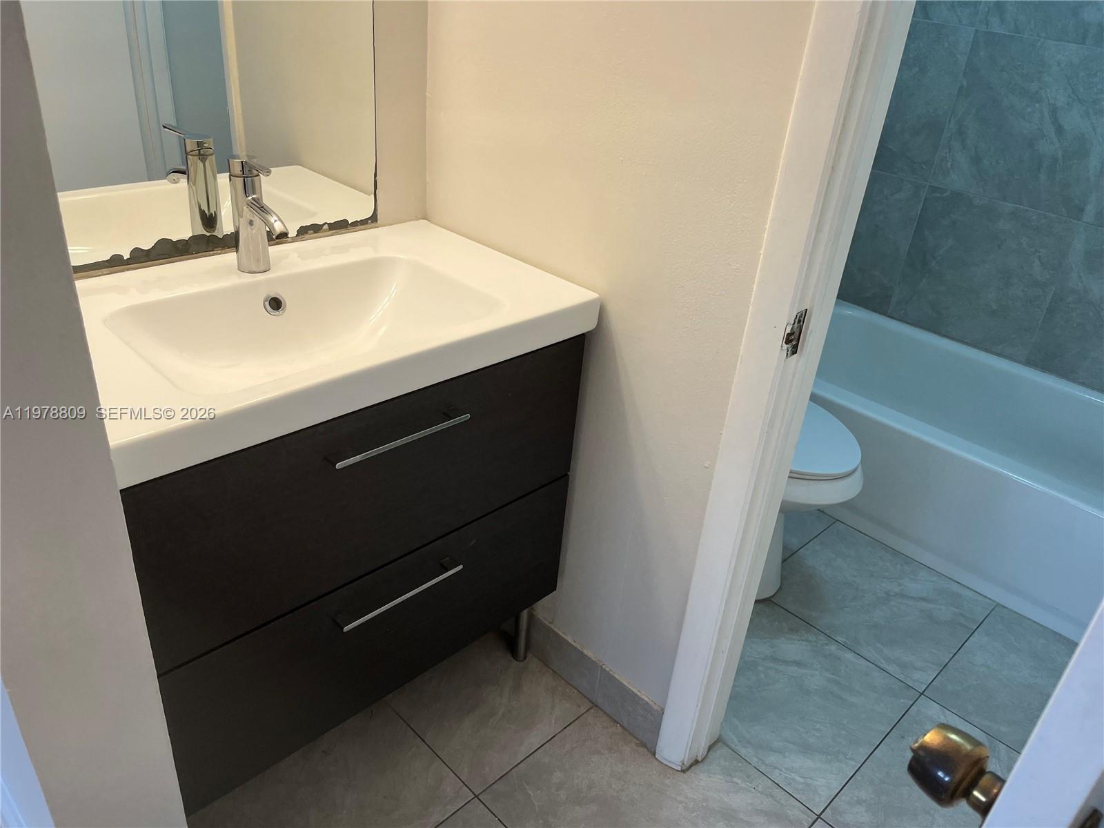 1250 Lincoln Road, Unit 310 Miami Beach, FL 33139 - Photo 21 of 27 a bathroom with a sink and a toilet