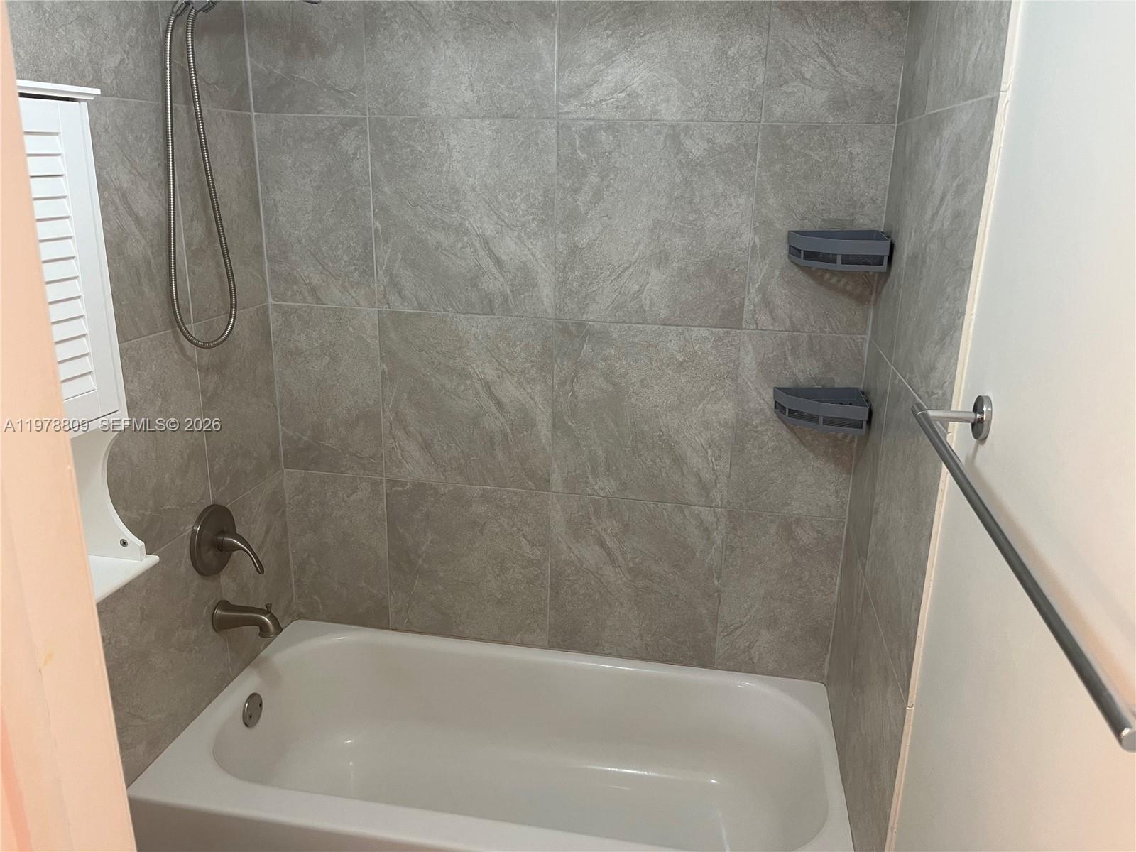 1250 Lincoln Road, Unit 310 Miami Beach, FL 33139 - Photo 22 of 27 a bathroom with a tub
