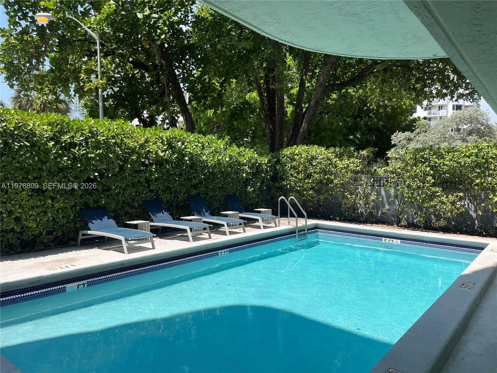 1250 Lincoln Road, Unit 310 Miami Beach, FL 33139 - Photo 24 of 27 a view of a swimming pool with chairs