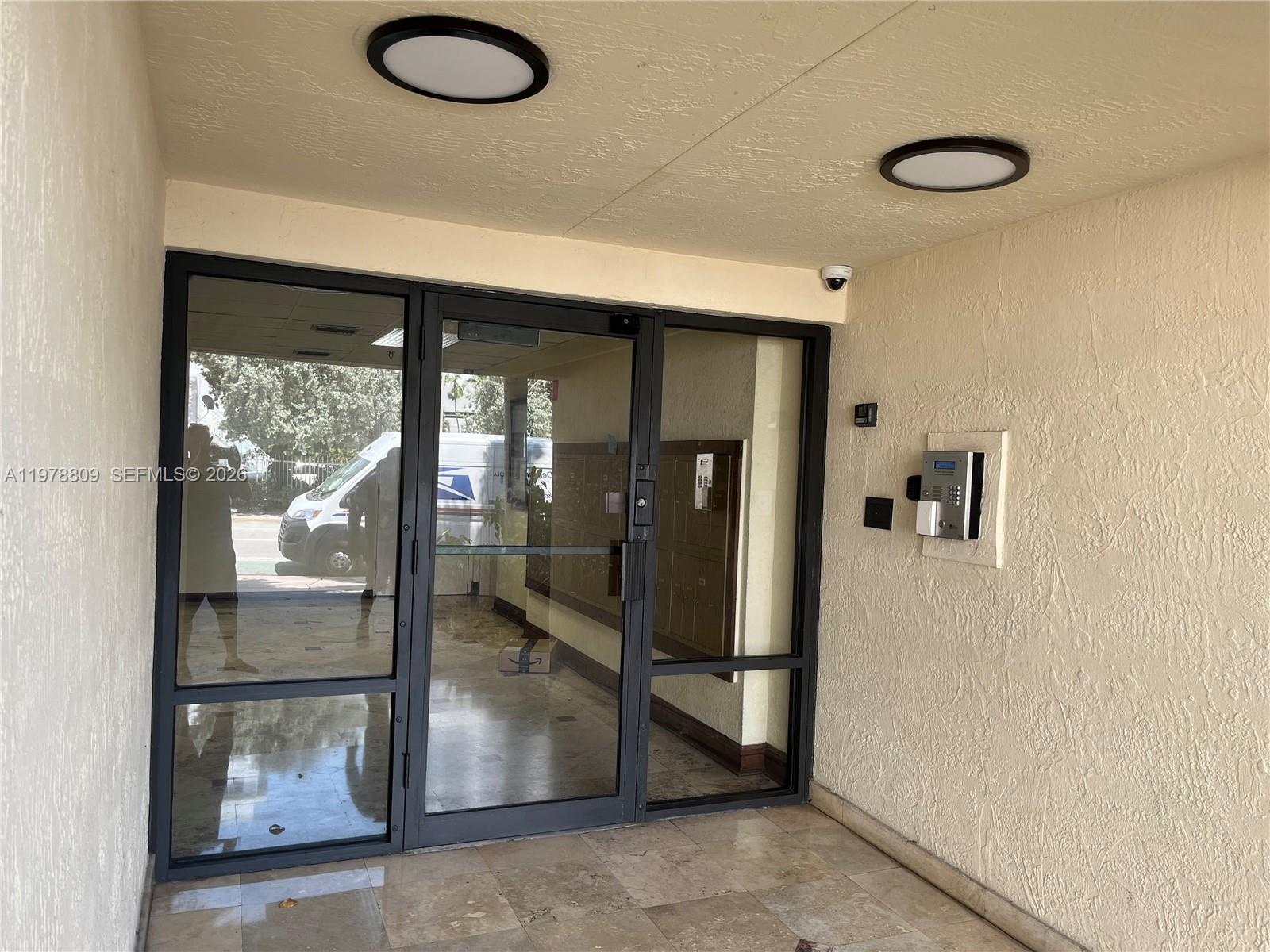 1250 Lincoln Road, Unit 310 Miami Beach, FL 33139 - Photo 4 of 27 a view of a hallway with a glass door