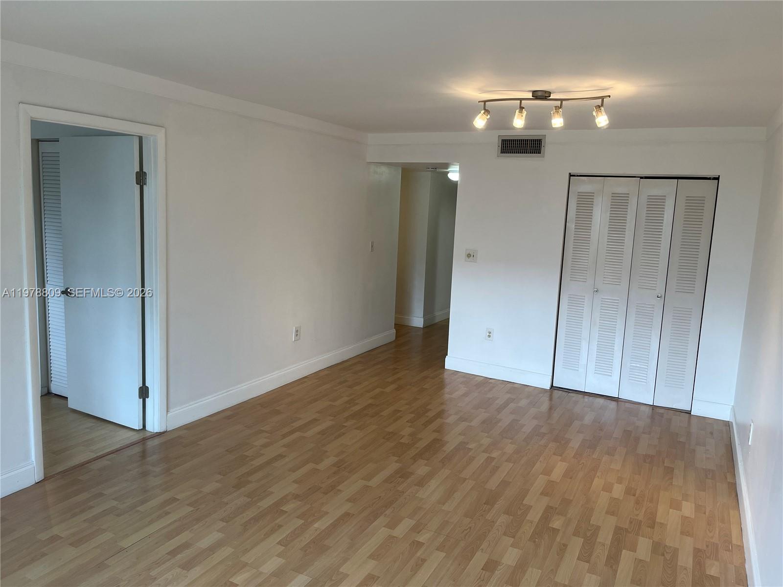 1250 Lincoln Road, Unit 310 Miami Beach, FL 33139 - Photo 10 of 27 an empty room with wooden floor