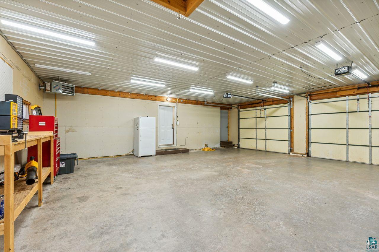 74050 Bjork Road Washburn, WI 54891 - Photo 20 of 33 Garage with a garage door opener and white fridge