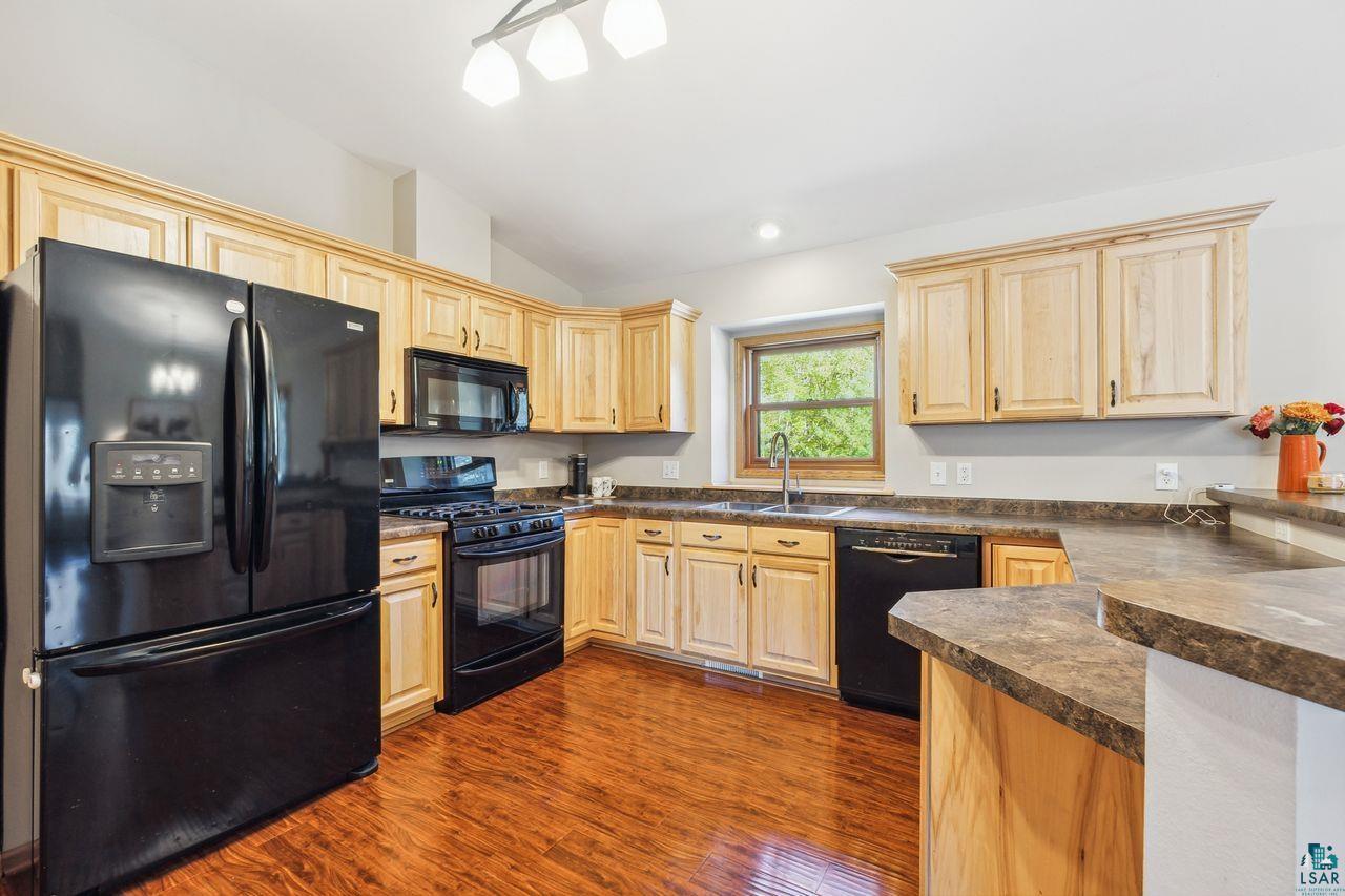 74050 Bjork Road Washburn, WI 54891 - Photo 6 of 33 Kitchen featuring lofted ceiling, black appliances, dark hardwood / wood-style floors, and sink