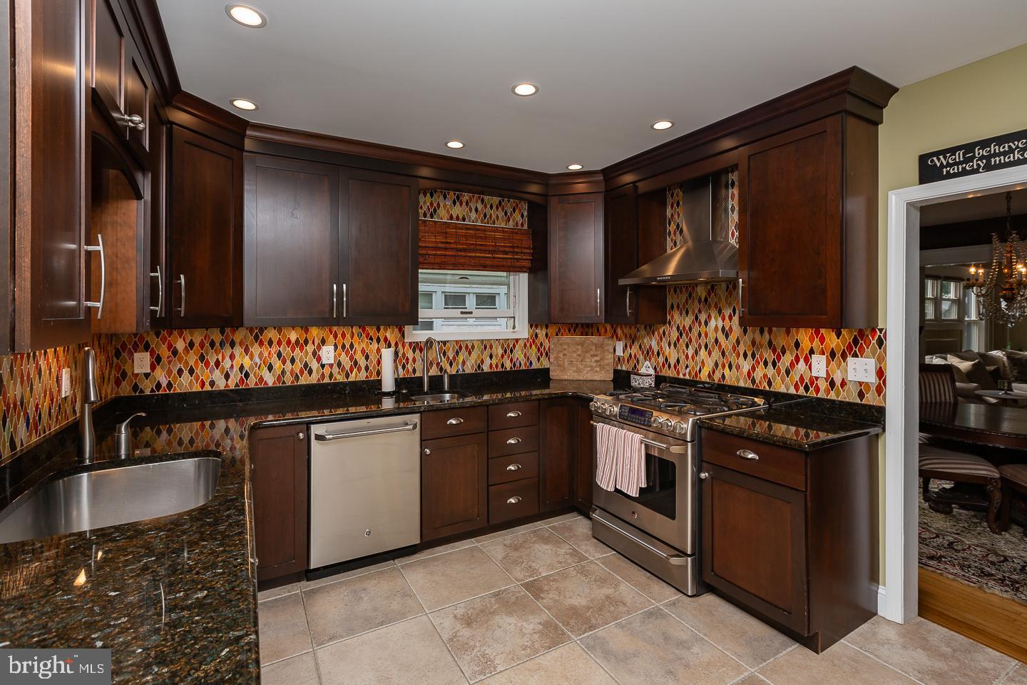 133 Kathmere Road Havertown, PA 19083 - Photo 16 of 45 a kitchen with stainless steel appliances granite countertop a stove a sink and a microwave