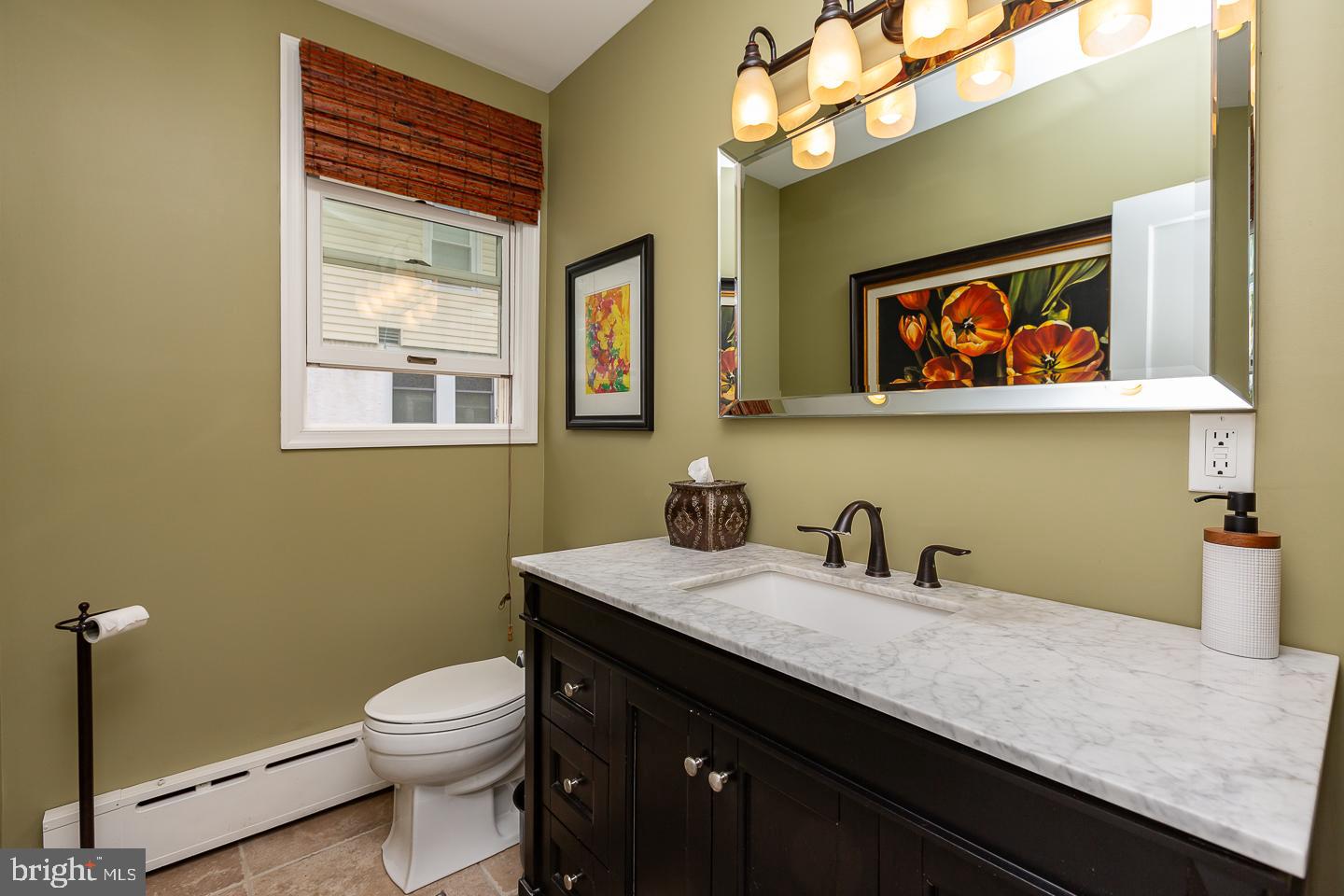 133 Kathmere Road Havertown, PA 19083 - Photo 21 of 45 a bathroom with a sink a mirror and a toilet