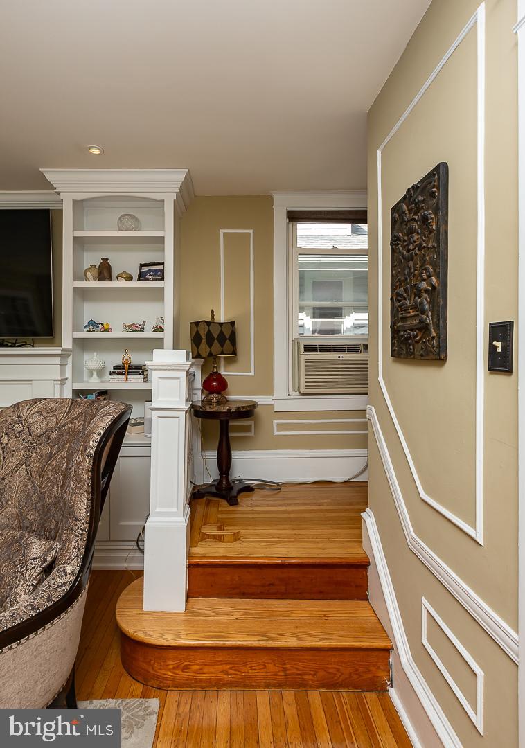 133 Kathmere Road Havertown, PA 19083 - Photo 22 of 45 a living room with fireplace furniture and a flat screen tv