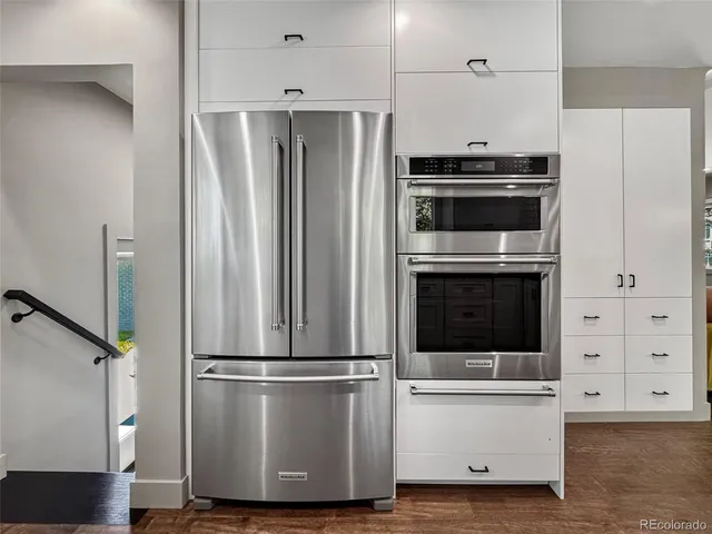 a view of kitchen with stainless steel appliances wooden floor and electronic appliances