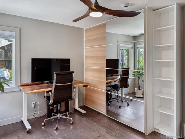 a view of a workspace with furniture and a window