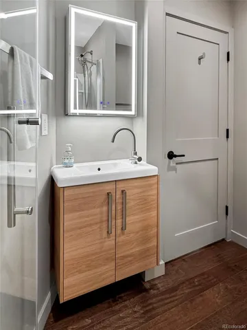 a bathroom with a sink a mirror and shower