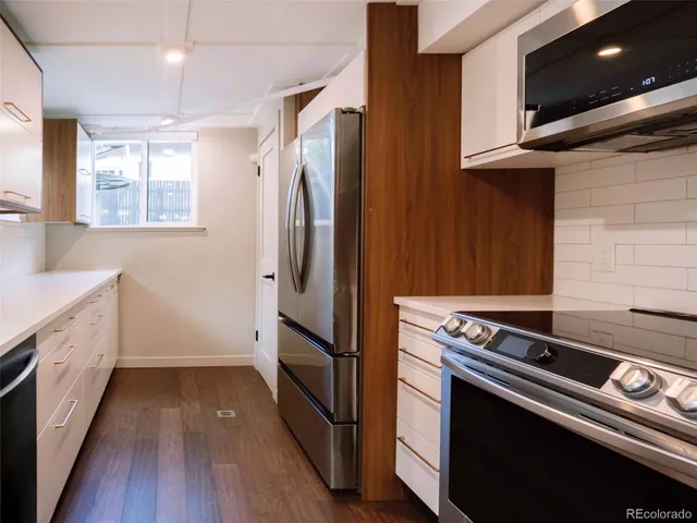 a kitchen with a stove and a refrigerator