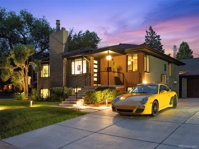 a view of a house with backyard and a tree