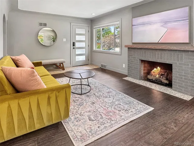 a living room with furniture and a fireplace
