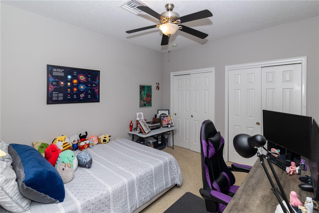 3305 Schoolhouse Road St. Cloud, FL 34773 - Photo 45 of 83 a bedroom with a bed and a flat screen tv