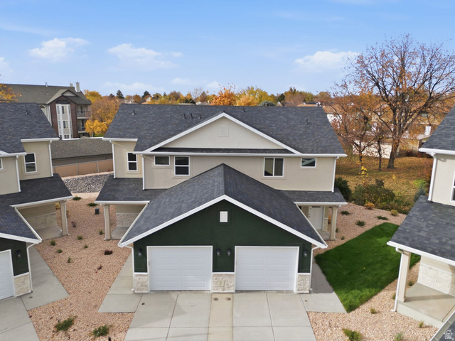 1619 North Angel Street West Layton, UT 84041 - Photo 2 of 32 View of front facade featuring stucco siding, a shingled roof, concrete driveway, and stone siding