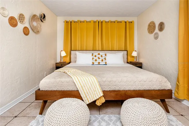 a bedroom with a bed and painting on the wall