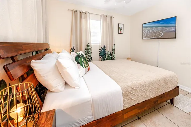 a bed sitting in a bedroom next to a window