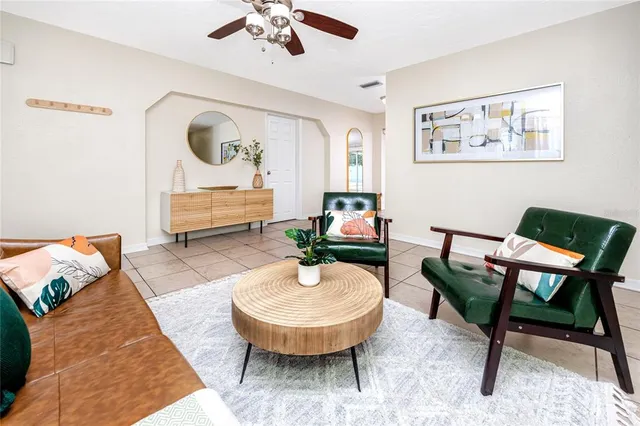 a living room with furniture and a mirror