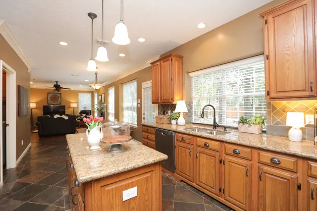 a kitchen with sink stove and cabinets
