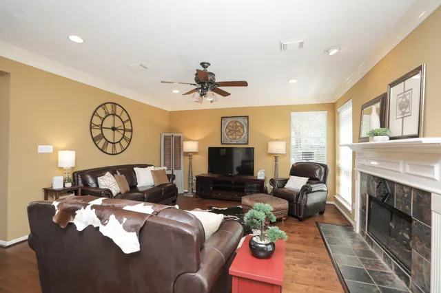 a living room with furniture a fireplace and a flat screen tv
