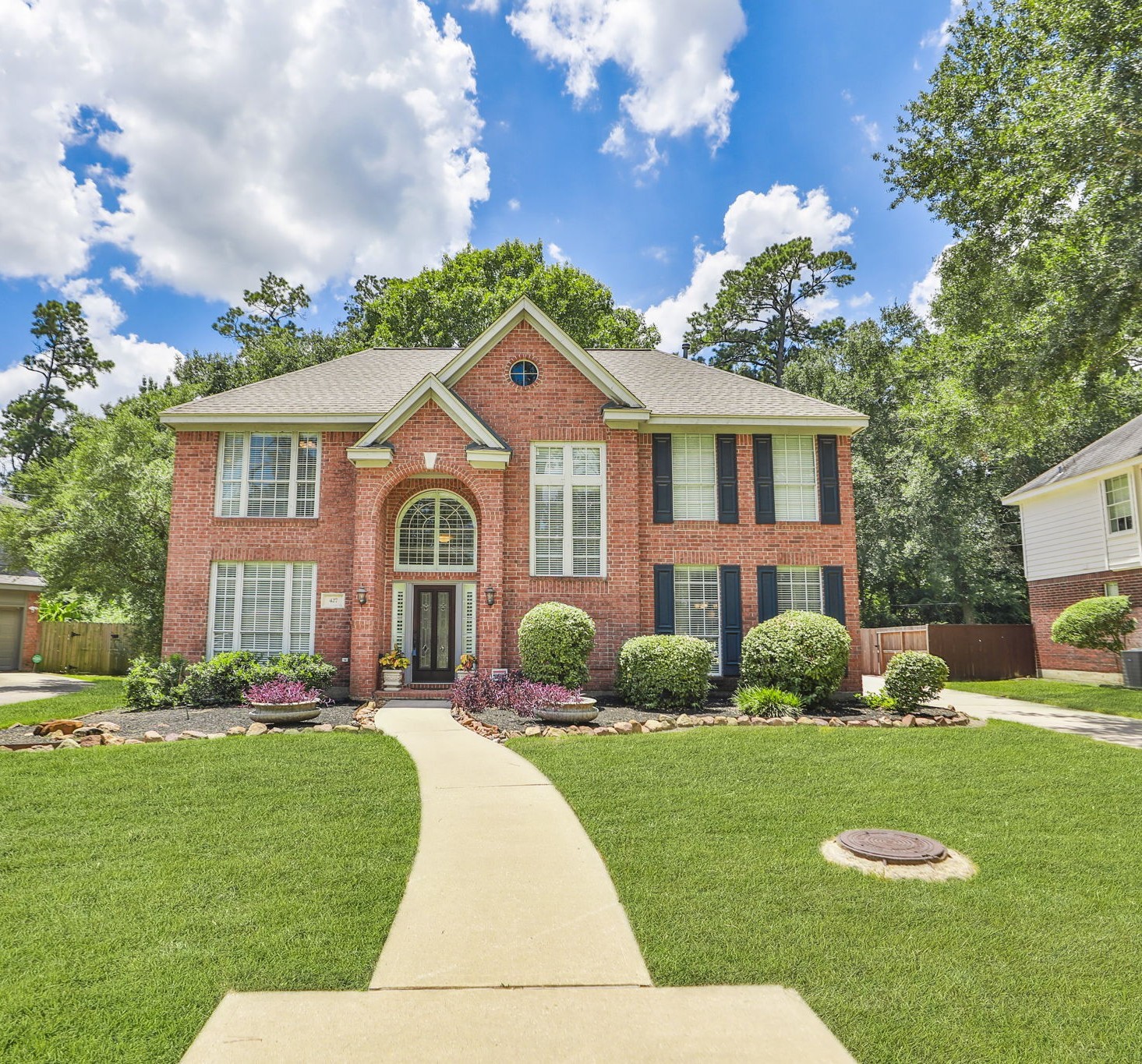 427 West North Hill Drive Spring, TX 77388 - Photo 2 of 41 a front view of a house with a garden