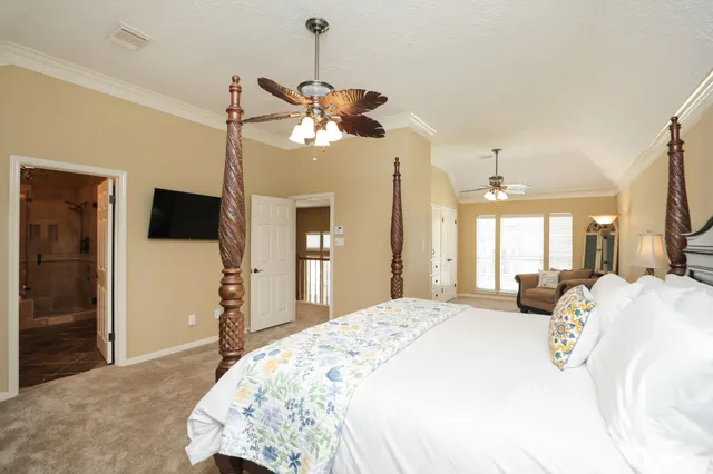 a bedroom with a bed window and a flat screen tv