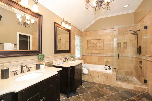 a spacious bathroom with a double vanity sink a mirror and a shower