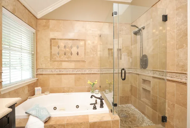 a bathroom with a bathtub and shower