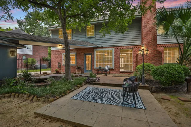 a view of backyard with outdoor seating and plants