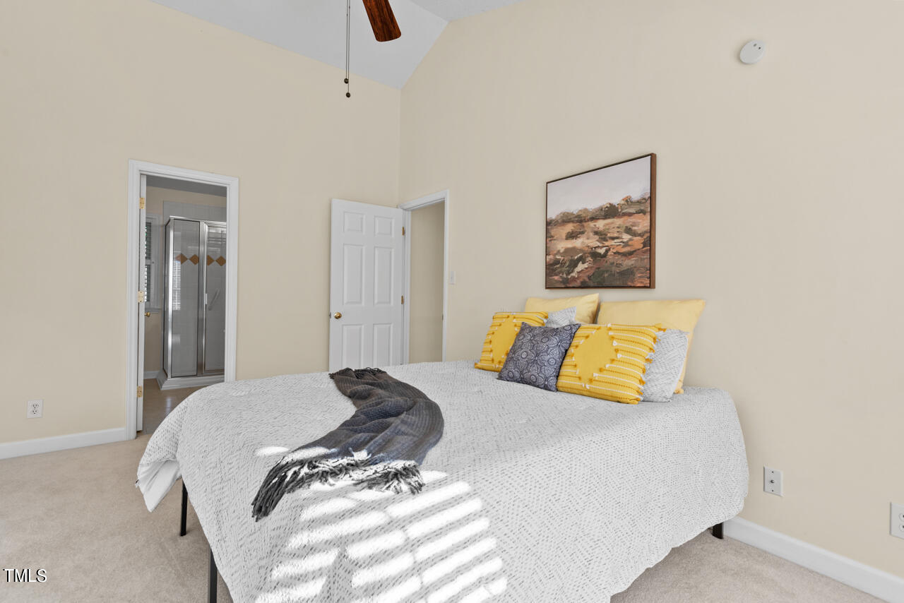 3100 Wilderness Road Durham, NC 27712 - Photo 22 of 35 a bedroom with a bed and painting on the wall