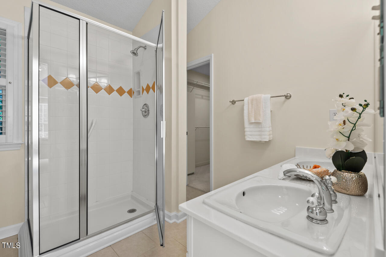 3100 Wilderness Road Durham, NC 27712 - Photo 23 of 35 a bathroom with a sink and shower