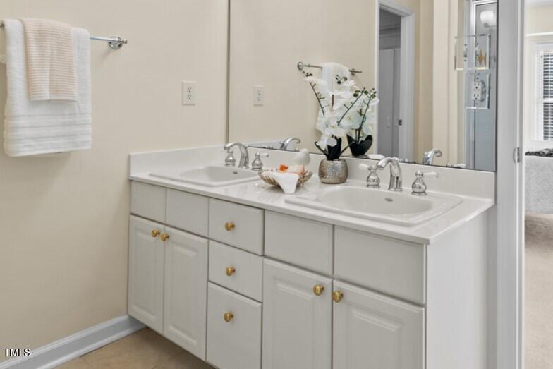 3100 Wilderness Road Durham, NC 27712 - Photo 24 of 35 a bathroom with a sink and a mirror