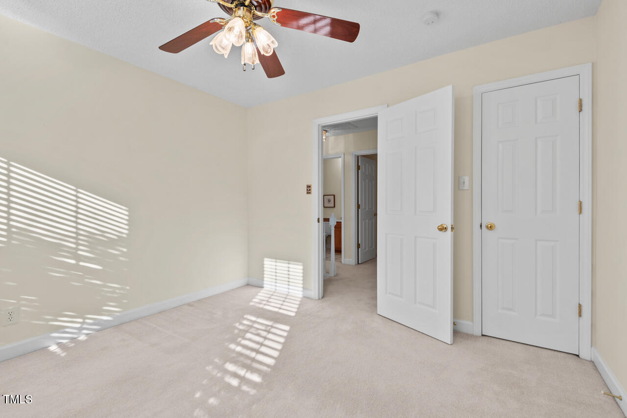 3100 Wilderness Road Durham, NC 27712 - Photo 27 of 35 an empty room with chandelier fan and windows