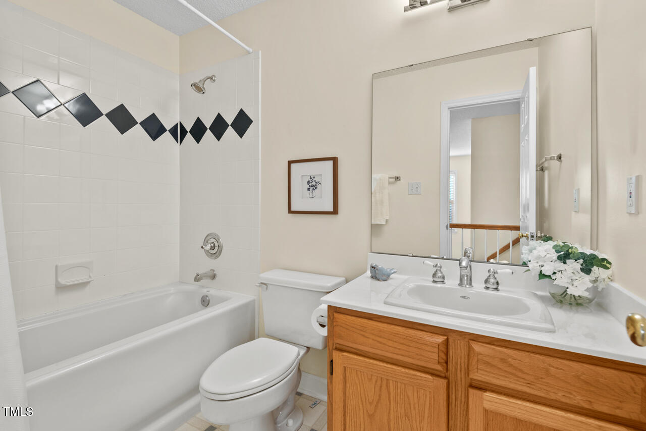 3100 Wilderness Road Durham, NC 27712 - Photo 28 of 35 a bathroom with a sink a toilet and a bathtub
