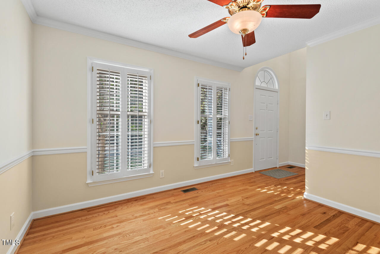 3100 Wilderness Road Durham, NC 27712 - Photo 4 of 35 a view of an empty room with a window and wooden floor