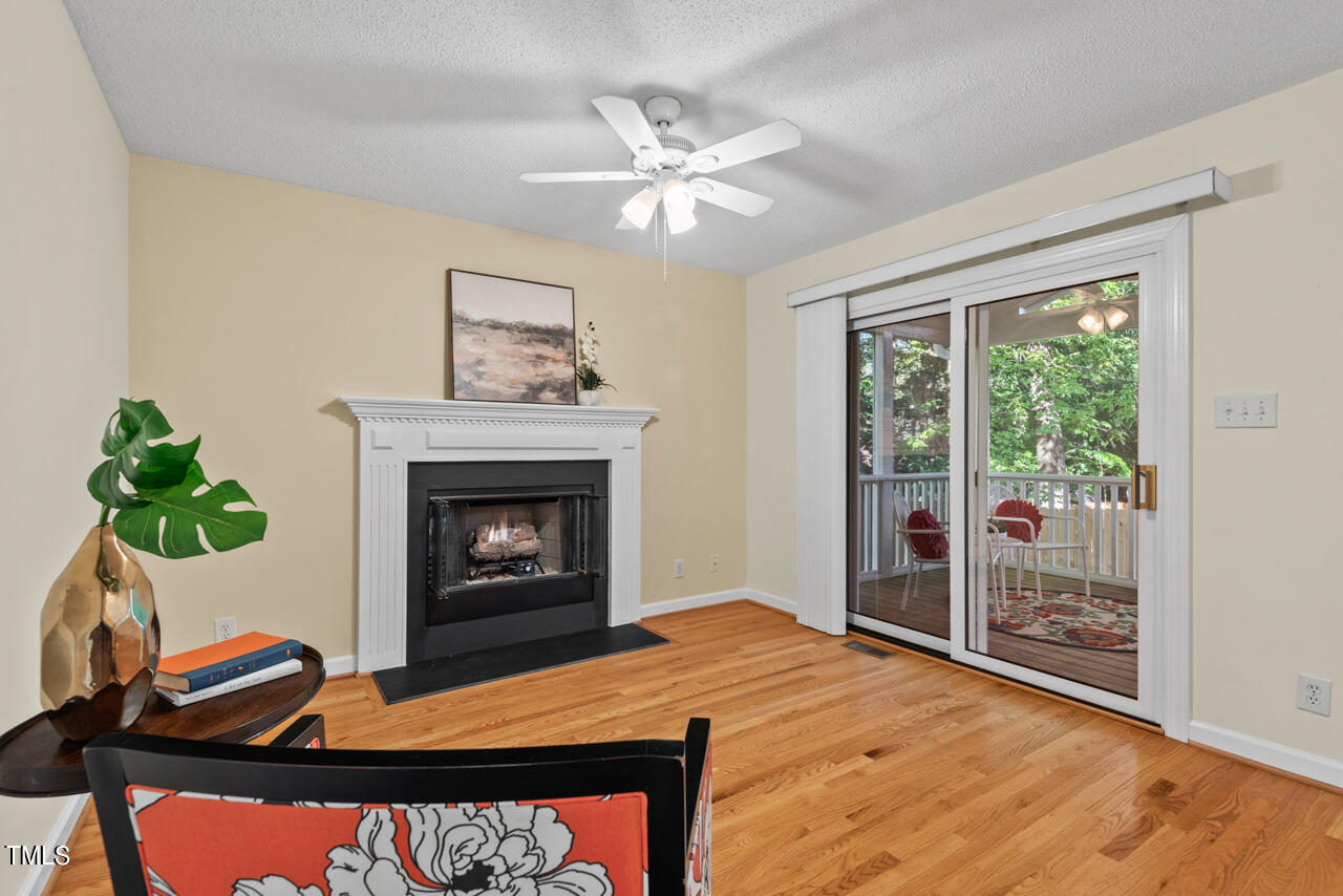 3100 Wilderness Road Durham, NC 27712 - Photo 8 of 35 a living room with furniture and a fireplace