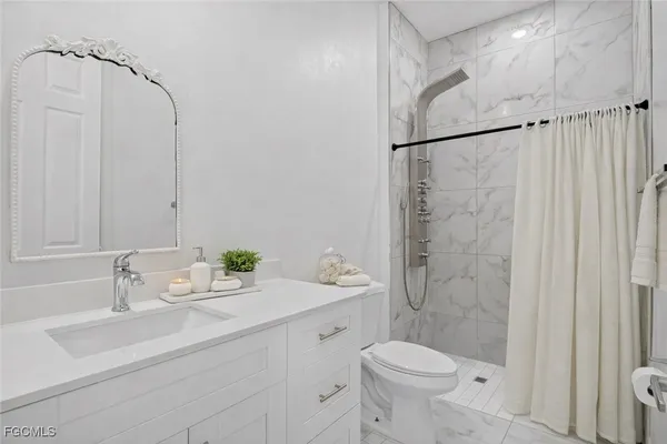 a bathroom with a sink toilet and shower