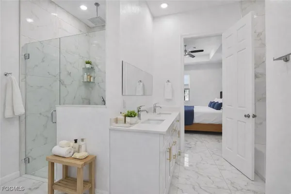 a en suite bathroom with a tub sink and mirror
