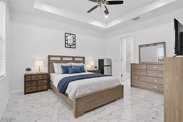 a bedroom with a bed and ceiling fan